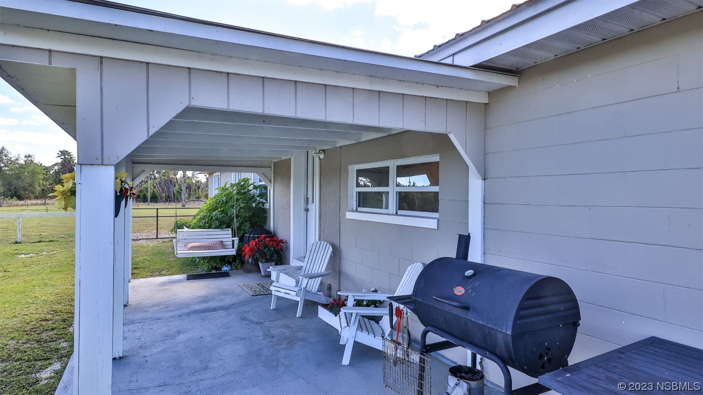677 State Rte 415 New Smyrna Beach, FL 32168 - Photo 8 of 74 a outdoor living space with furniture and garden view