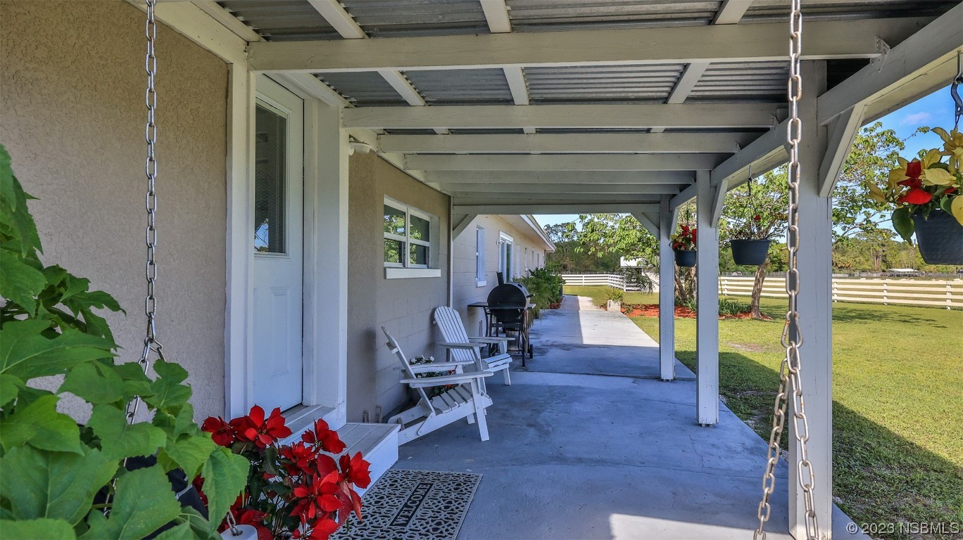 677 State Rte 415 New Smyrna Beach, FL 32168 - Photo 9 of 74 a view of an outdoor space with seating