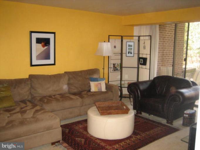1533 Northgate Square, Unit 33/1A Reston, VA 20190 - Photo 2 of 6 a living room with furniture and a couch