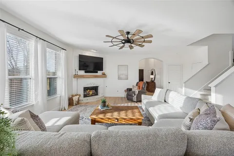 a living room with furniture and a view of kitchen