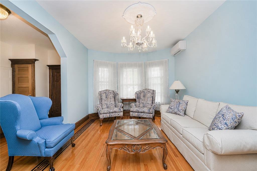 1352 Bay Ridge Parkway Brooklyn, NY 11228 - Photo 13 of 42 a living room with furniture flowerpot and a chandelier