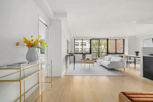 a living room with furniture and a floor to ceiling window