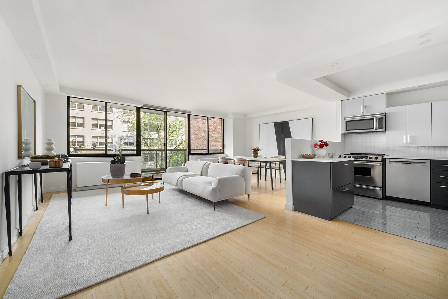 510 East 80th Street, Unit 4F Manhattan, NY 10075 - Photo 3 of 15 a living room with furniture and a table