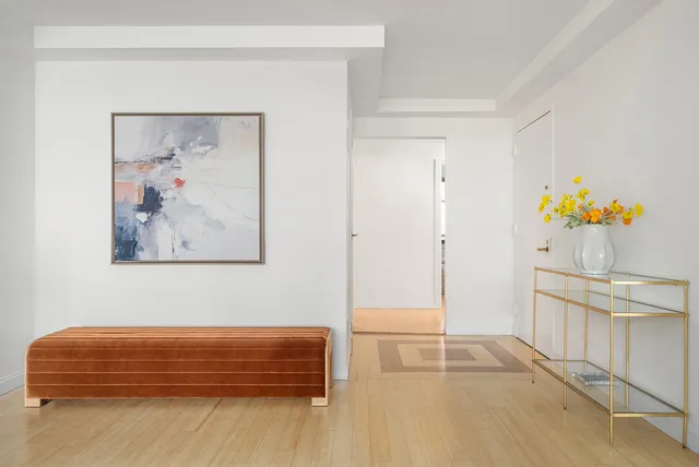 a view of a dining room with furniture and a window