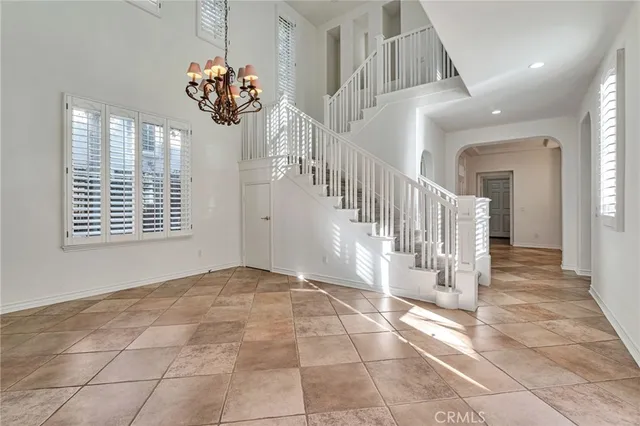 a front view of a house with a yard and potted plants