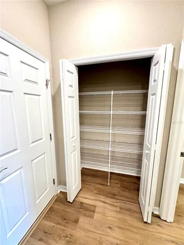 an empty room with a projector and a fireplace