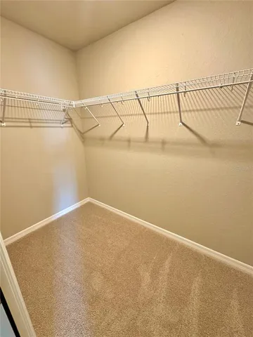 a white toilet sitting next to a white wall