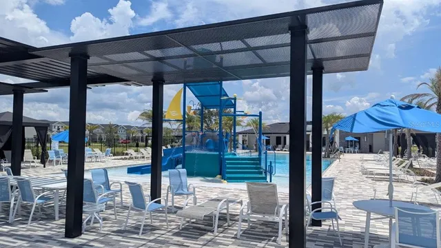 a roof deck with table and chairs a fire pit and a yard