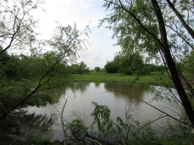 a view of lake with green space