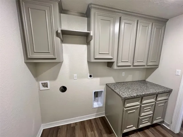 a kitchen with white cabinets and sink