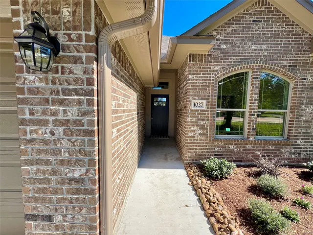 a view of a brick house with a large windows