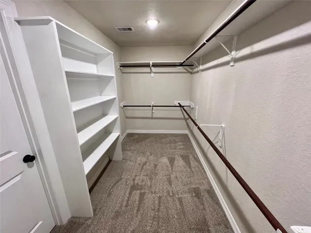 a view of a hallway with wooden floor and entryway