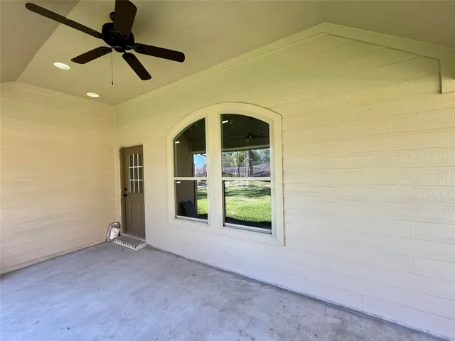 a view of empty room with ceiling fan