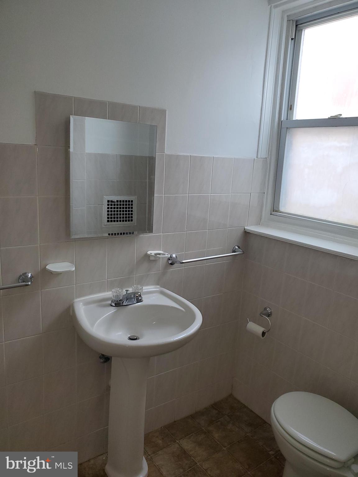 3050 Memphis Street Philadelphia, PA 19134 - Photo 12 of 20 a bathroom with a sink toilet and mirror