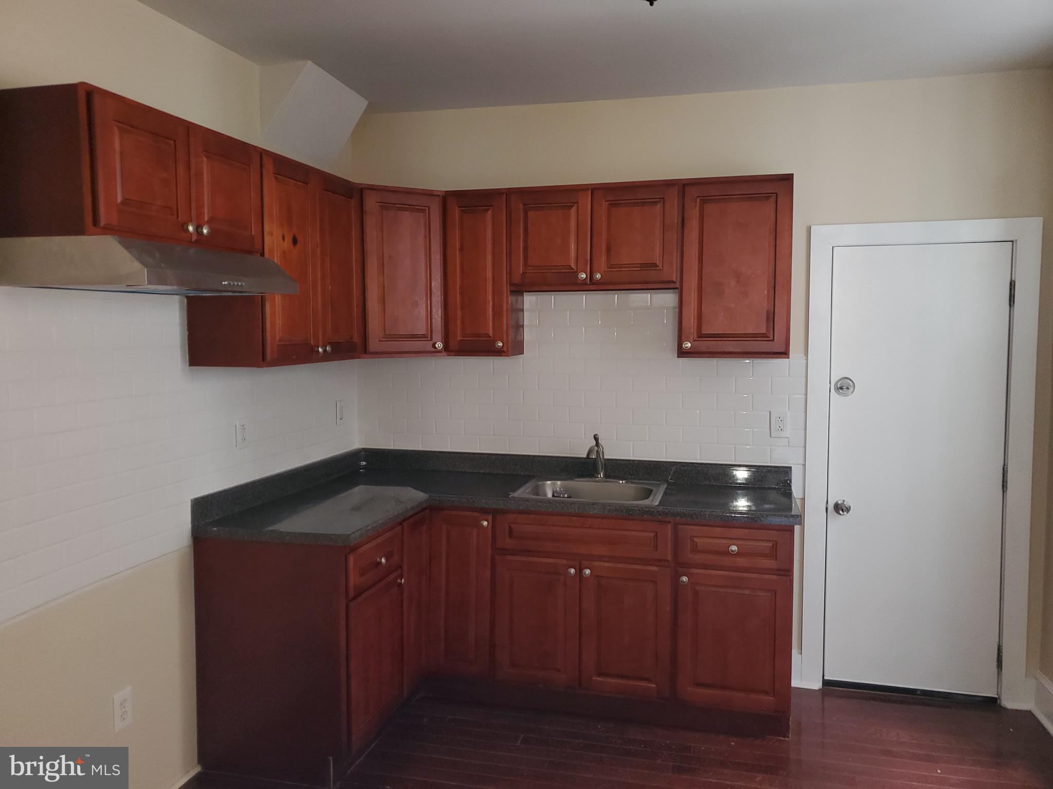 3050 Memphis Street Philadelphia, PA 19134 - Photo 3 of 20 a kitchen with granite countertop wood cabinets and granite counter tops