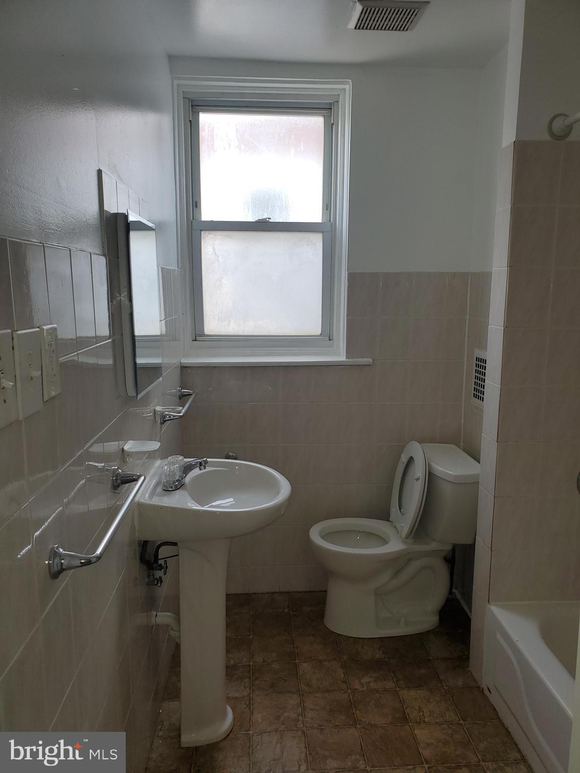 3050 Memphis Street Philadelphia, PA 19134 - Photo 9 of 20 a bathroom with a sink toilet and a mirror