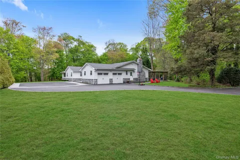 a view of house with garden space and trees