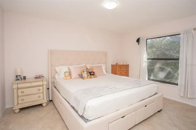 a bedroom with a bed and a window