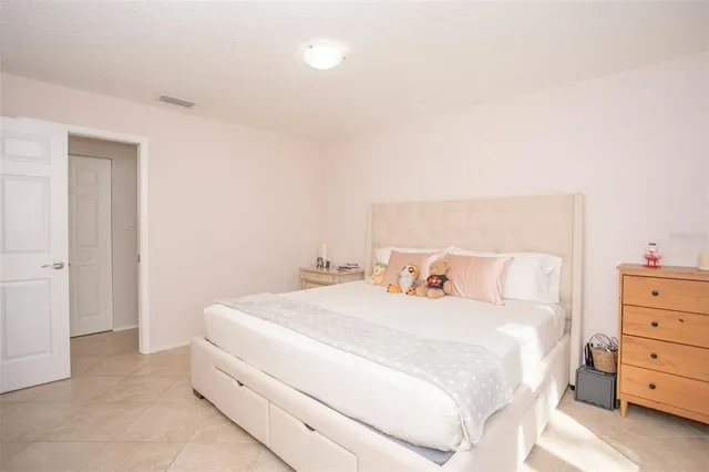 a bedroom with a bed and a night stand