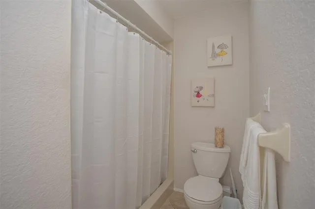 a white toilet sitting next to a small bathroom sink