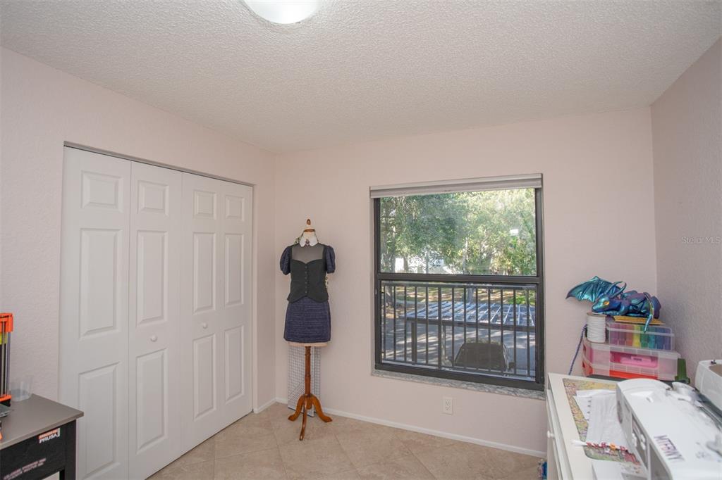 11511 113th Street, Unit 13H Largo, FL 33778 - Photo 17 of 28 a bedroom with a bed and a window