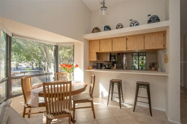 a dining room with furniture a window and kitchen view