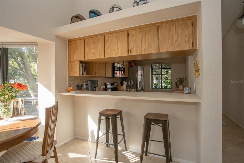 11511 113th Street, Unit 13H Largo, FL 33778 - Photo 22 of 28 a kitchen with stainless steel appliances granite countertop a refrigerator and microwave