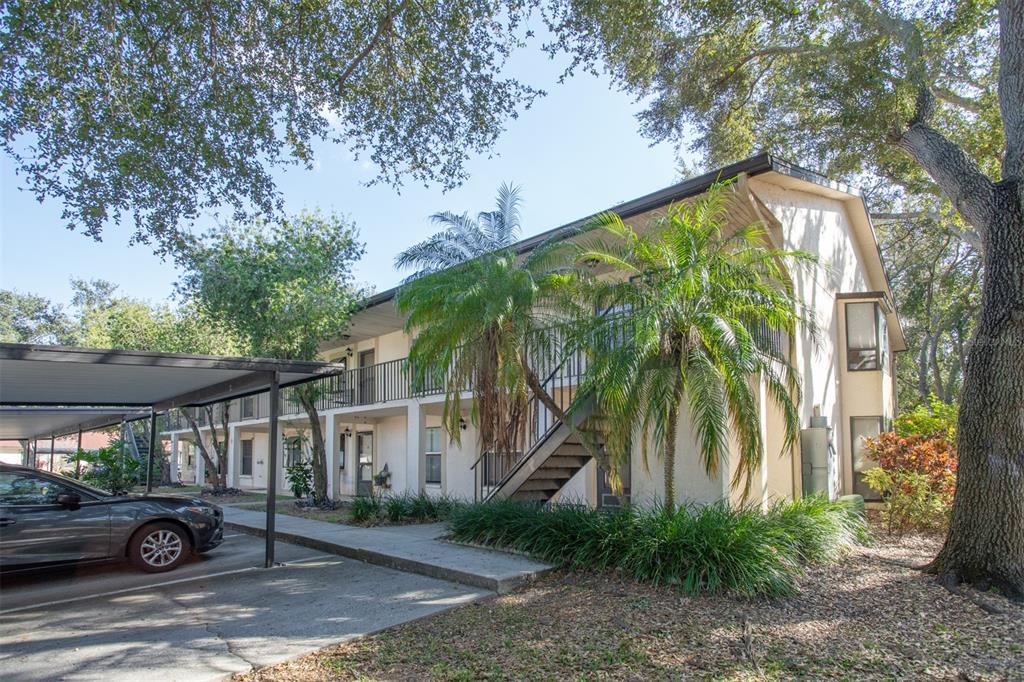 11511 113th Street, Unit 13H Largo, FL 33778 - Photo 25 of 26 a front view of a house with garden
