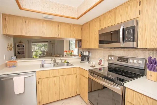 a kitchen with stainless steel appliances a sink stove and cabinets