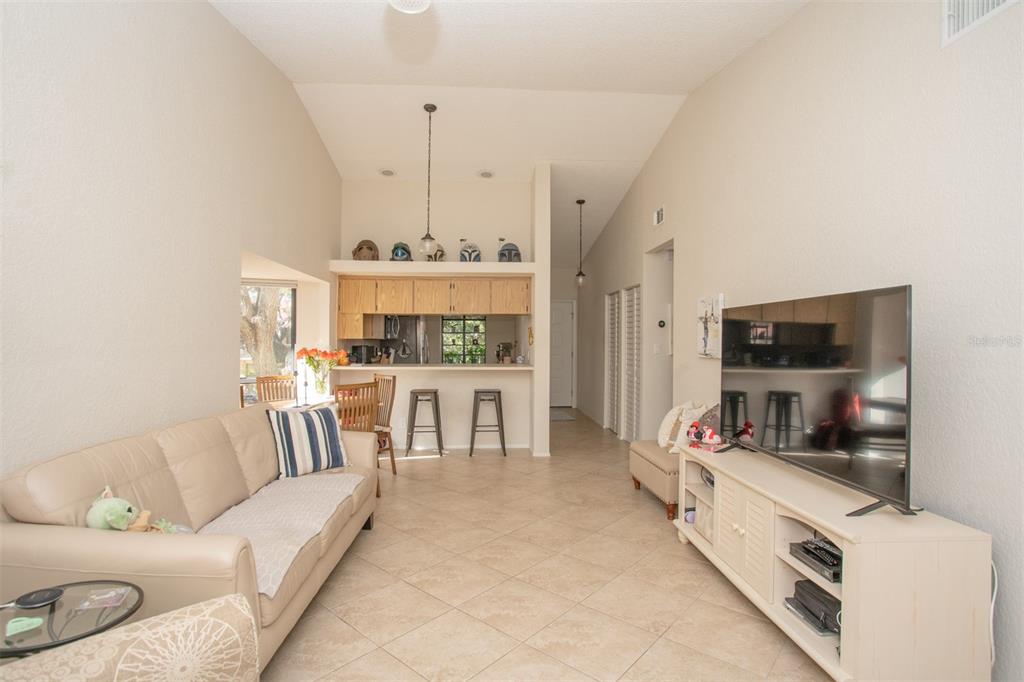 11511 113th Street, Unit 13H Largo, FL 33778 - Photo 5 of 28 a living room with furniture and a flat screen tv