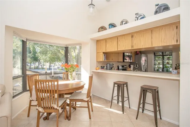 a dining table with chairs and view of kitchen