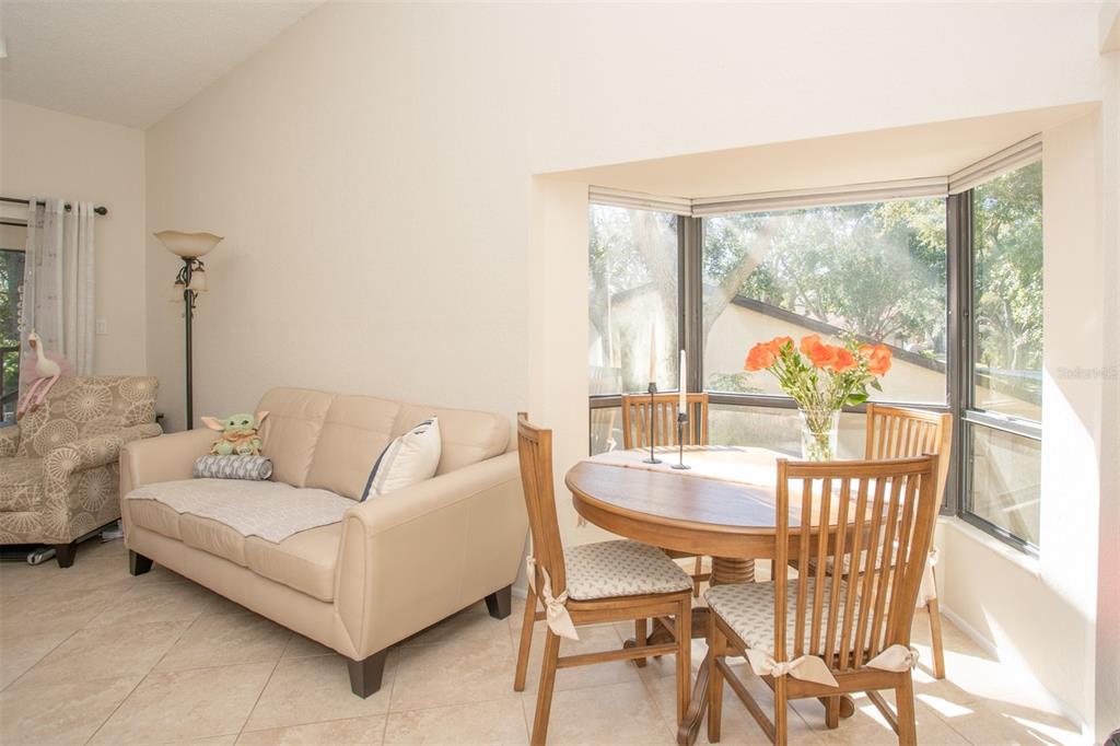 11511 113th Street, Unit 13H Largo, FL 33778 - Photo 8 of 28 a living room with furniture and a large window