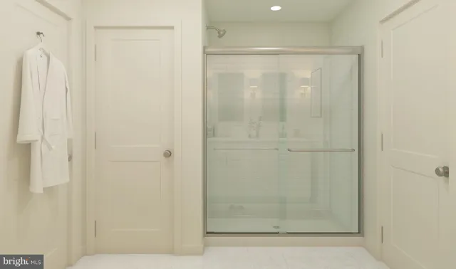 a bathroom with a glass shower door