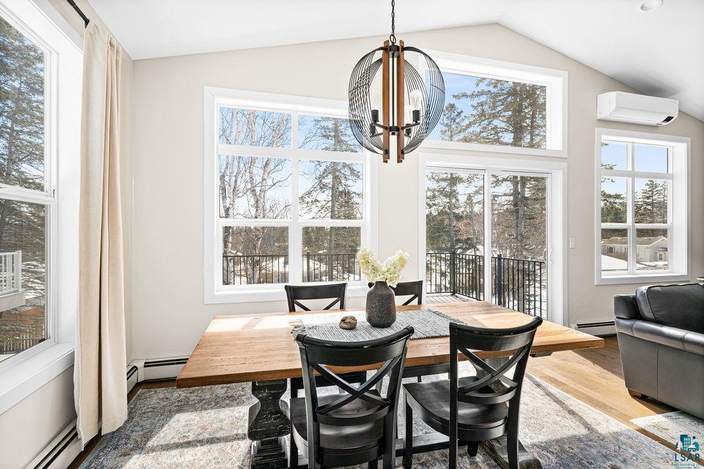 2236 Hoover Street Duluth, MN 55811 - Photo 12 of 52 Dining room with light wood finished floors, baseboard heating, vaulted ceiling, and hanging lights