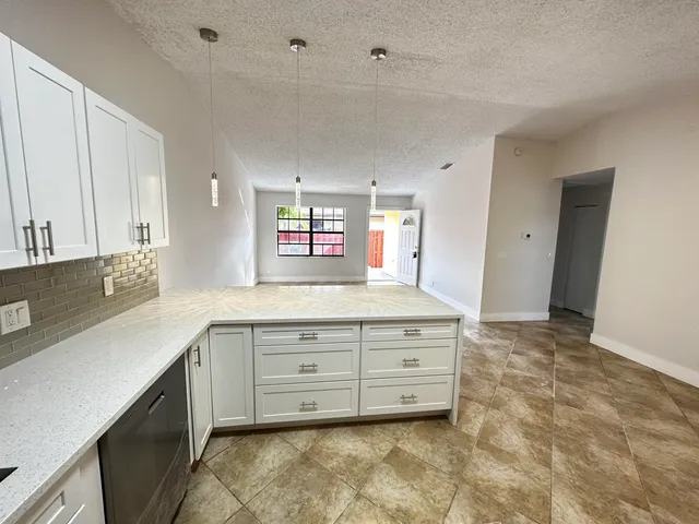 a spacious bathroom with a sink and a mirror