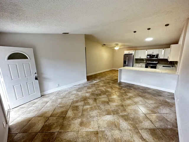 a view of kitchen with sink and cabinets