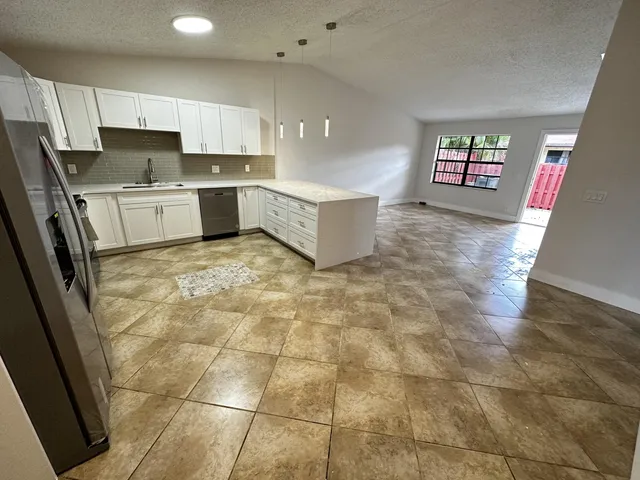 a kitchen with stainless steel appliances a sink a stove a microwave and cabinets