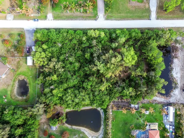 an aerial view of residential houses with outdoor space and swimming pool