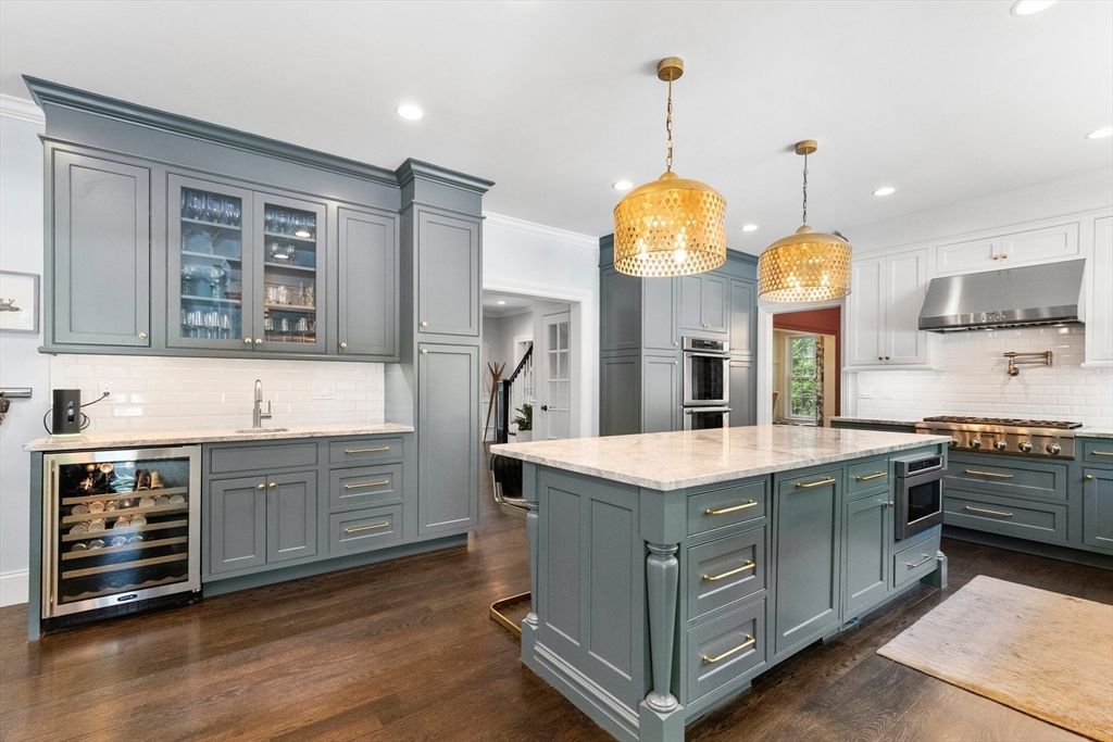 12 Cooke Road Lexington, MA 02420 - Photo 11 of 42 a kitchen with kitchen island granite countertop a stove and a center island