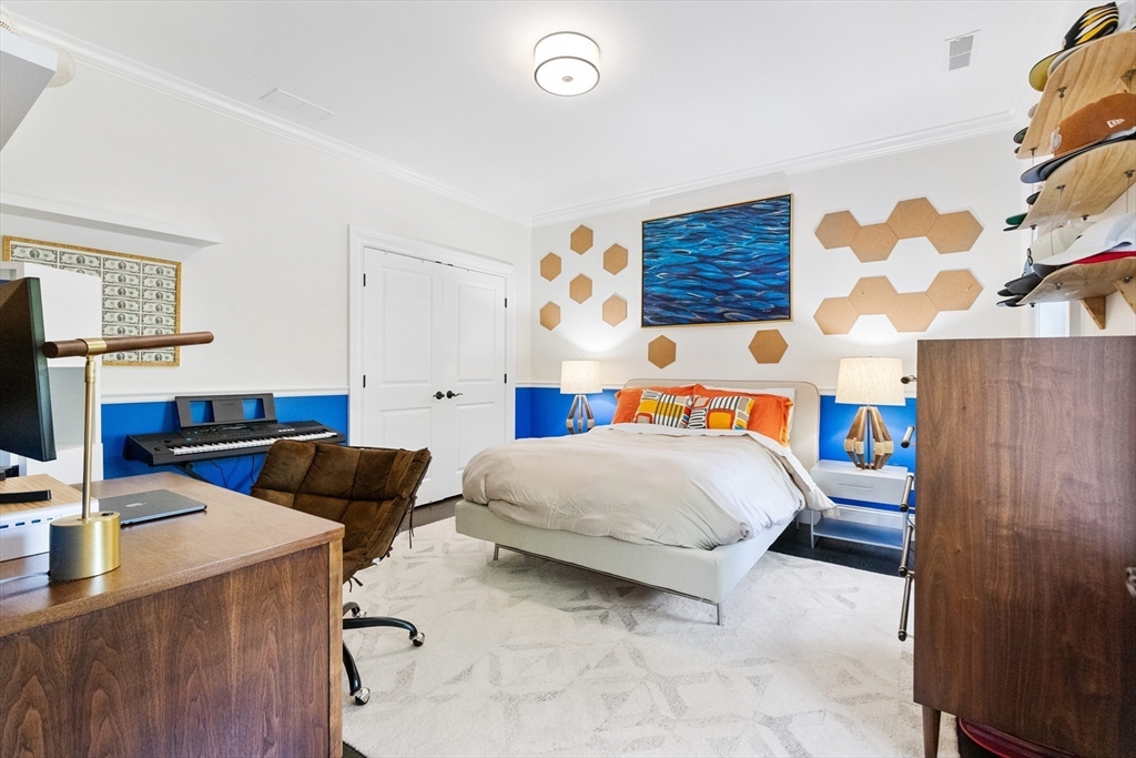 12 Cooke Road Lexington, MA 02420 - Photo 28 of 42 a bedroom with a bed and a flat screen tv