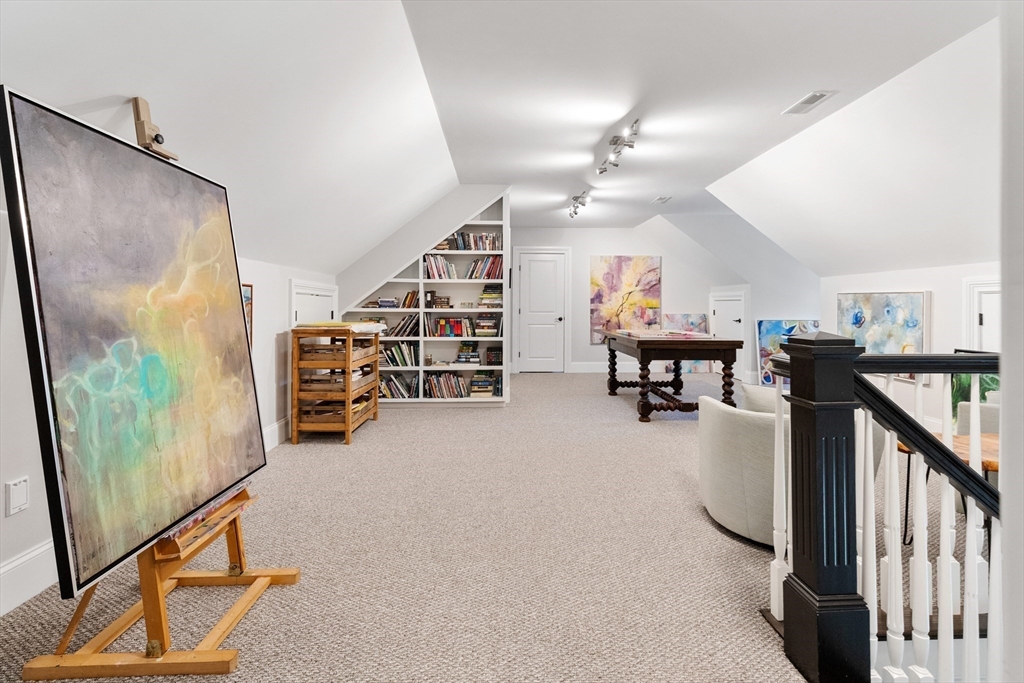 12 Cooke Road Lexington, MA 02420 - Photo 30 of 42 a view of a livingroom with furniture and a flat screen tv