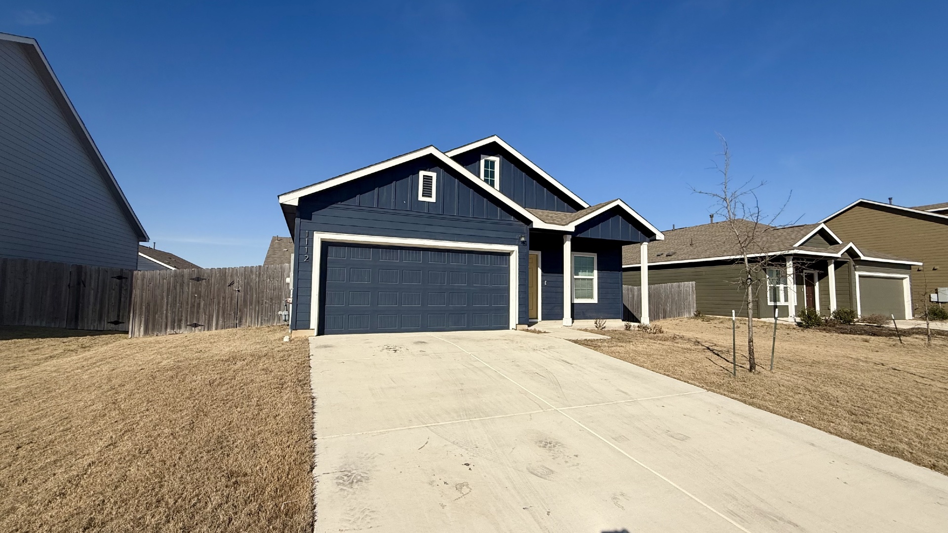 1112 Rio Frio Lane Georgetown, TX 78626 - Photo 2 of 21 View of front of property featuring board and batten siding, concrete driveway, and an attached garage