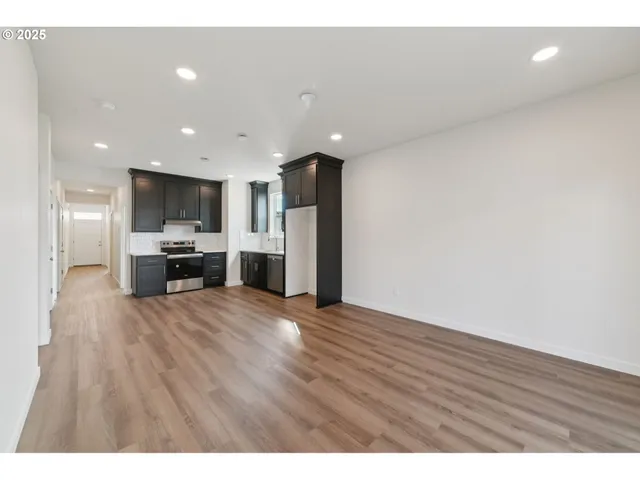 a view of kitchen with refrigerator and a window