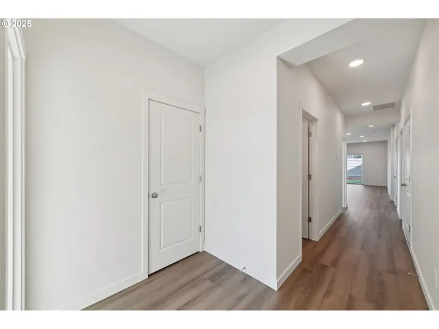 a view of hallway with wooden floor