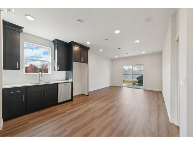 a view of kitchen with refrigerator sink and wooden floor