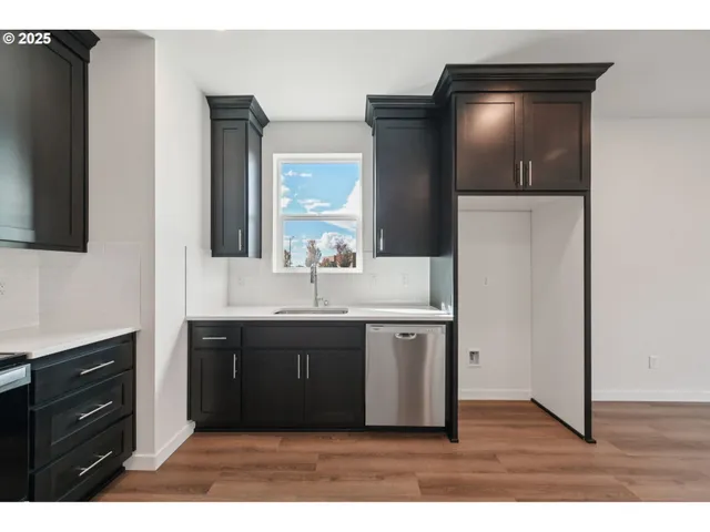 a kitchen with a refrigerator and a sink