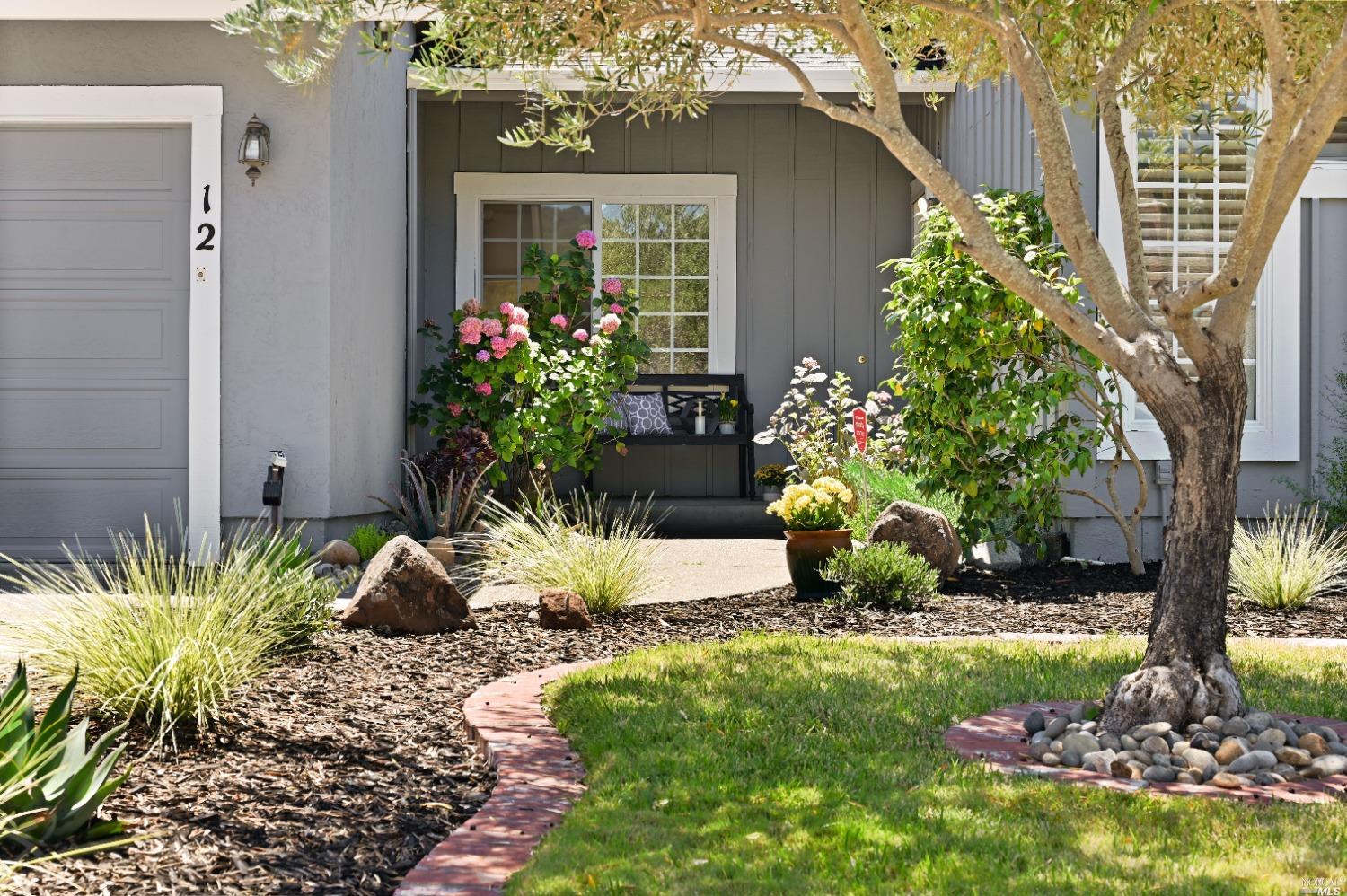 a view of a house with a yard and garden