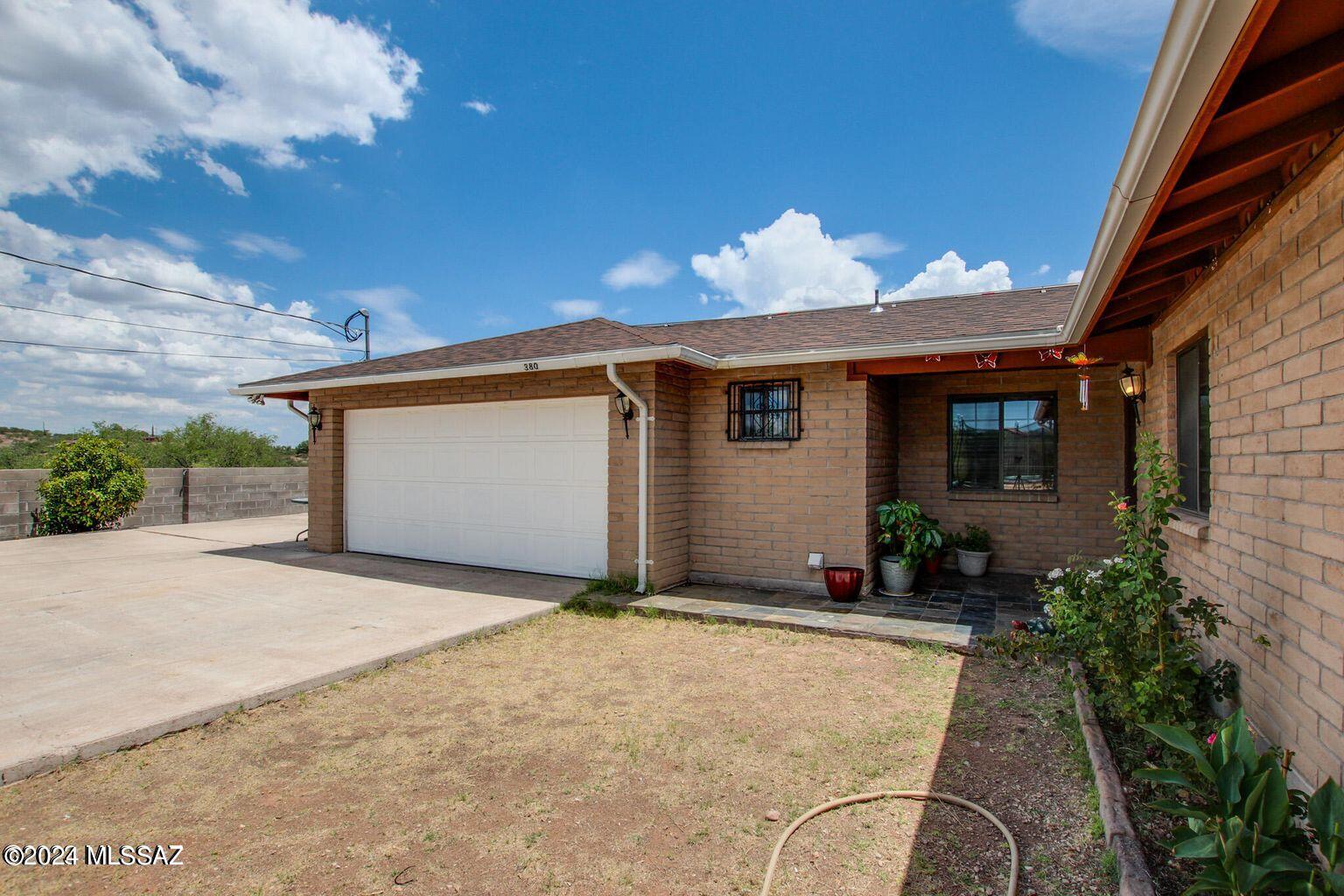 380 Paseo Ardilla Rio Rico, AZ 85648 - Photo 1 of 9 a front view of house with yard