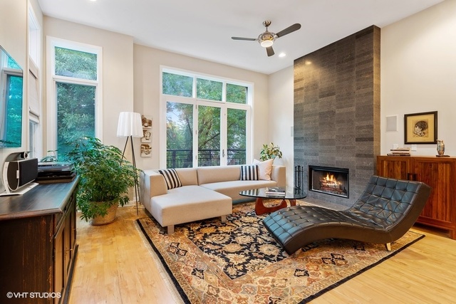 2029 West Rice Street, Unit 3 Chicago, IL 60622 - Photo 2 of 11 a living room with furniture and a fireplace