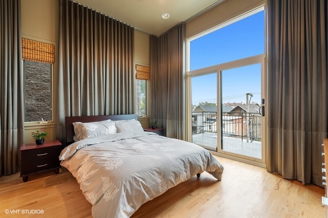 2029 West Rice Street, Unit 3 Chicago, IL 60622 - Photo 5 of 11 a bedroom with a bed and a large window